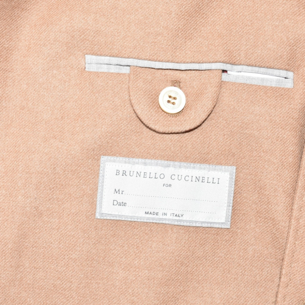 Brunello Cucinelli salmon cashmere garment interior label detail showing Made in Italy tag