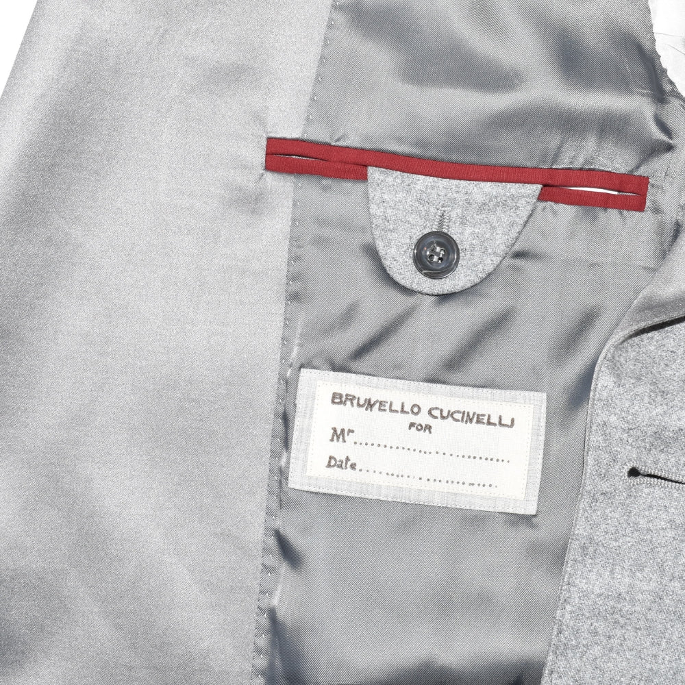 Brunello Cucinelli coat interior label detail with grey silk lining and red accent ribbon