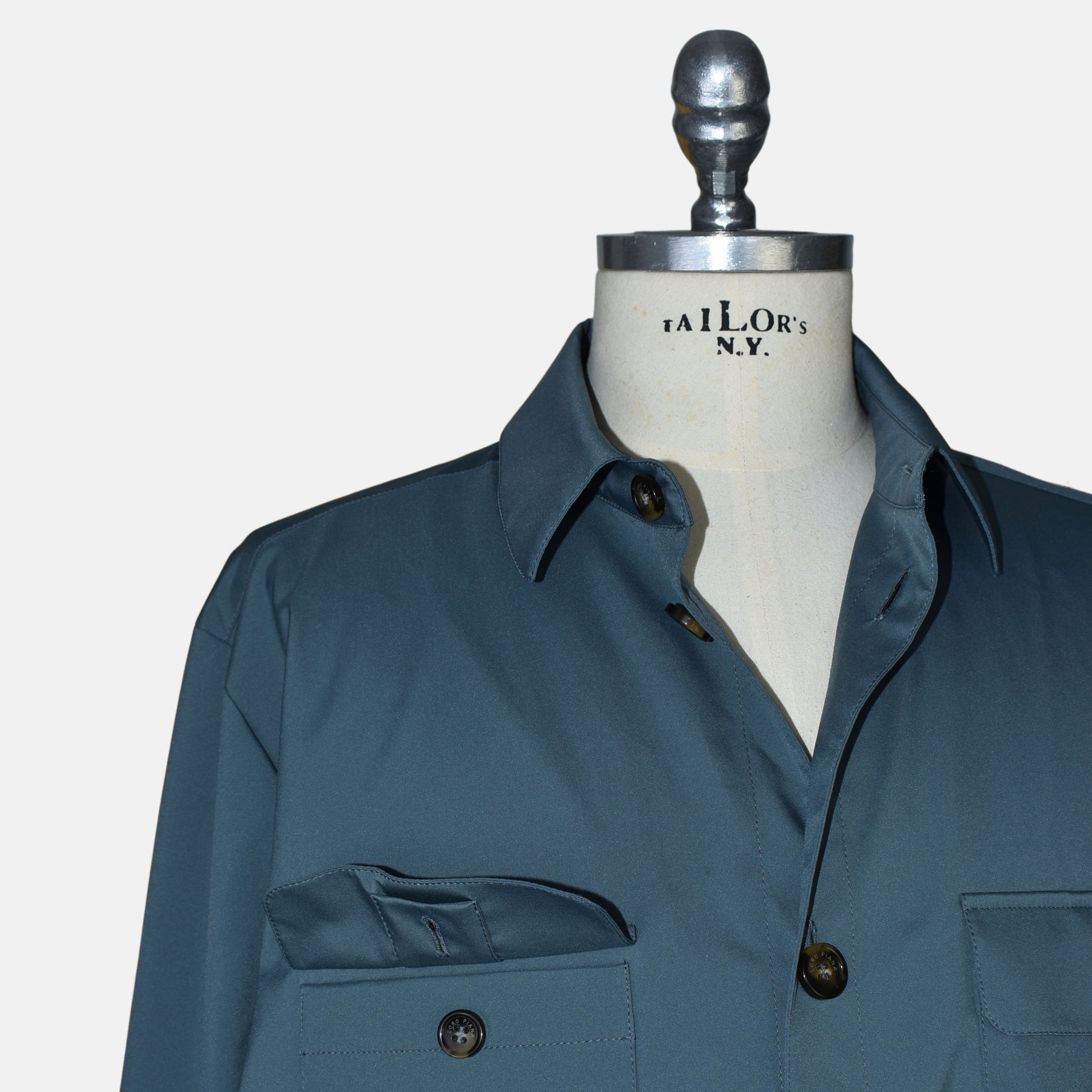 Close-up of a flap chest pocket with Loro Piana engraved button