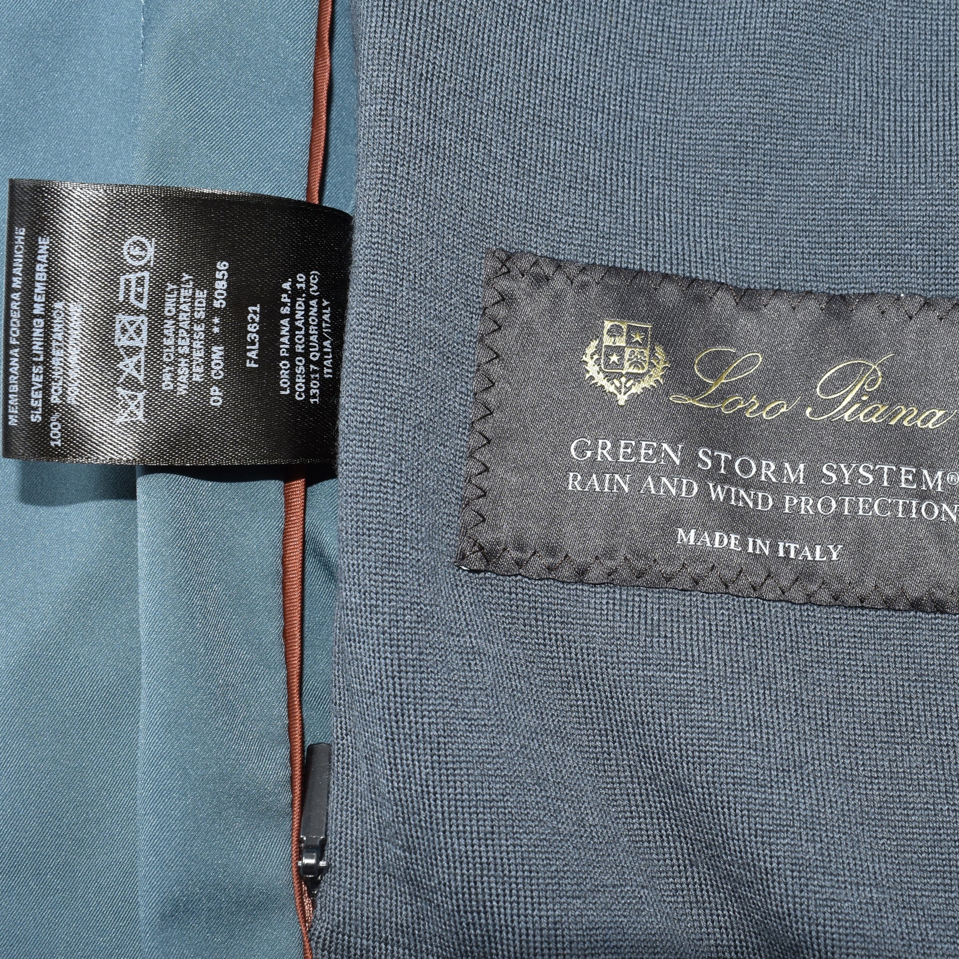 Loro Piana Green Storm System label confirming rain and wind protection, made in Italy