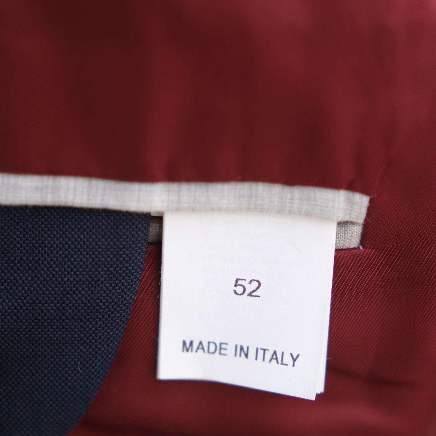 Close-up of the suit jacket's size 52 and Made in Italy label