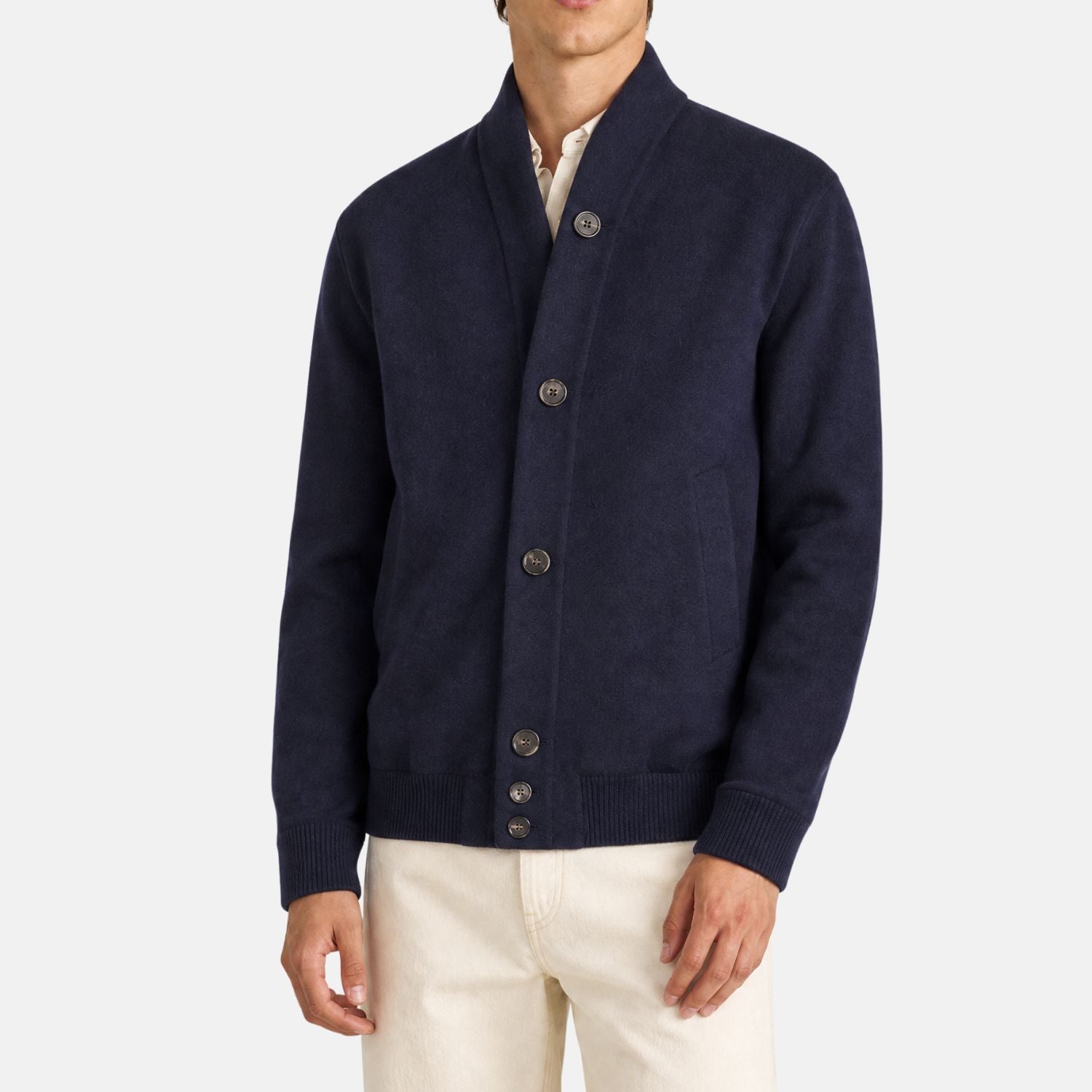 Man wearing a Loro Piana navy cashmere bomber jacket with shawl collar and button placket