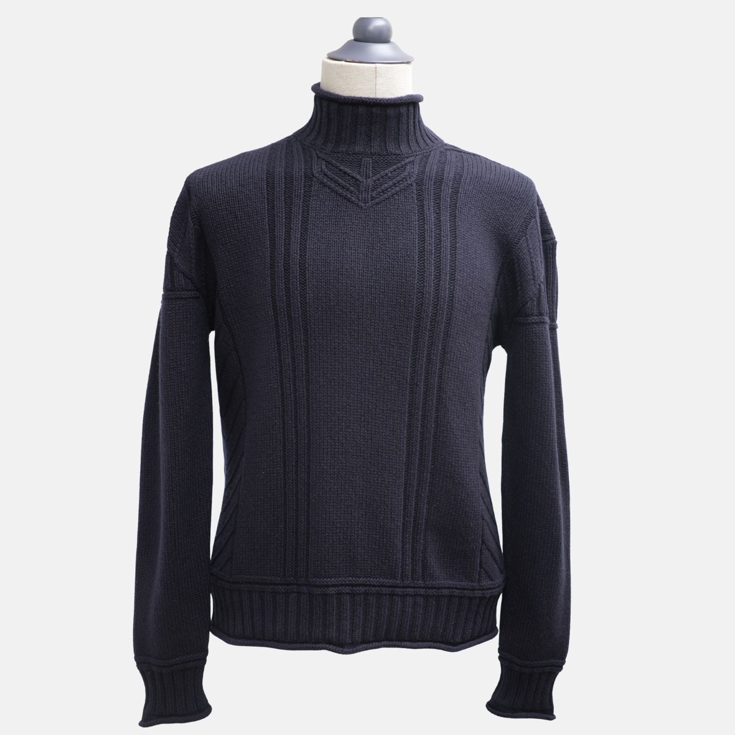 Navy blue Loro Piana ribbed cashmere turtleneck on a mannequin, front view with vertical cable-knit panels