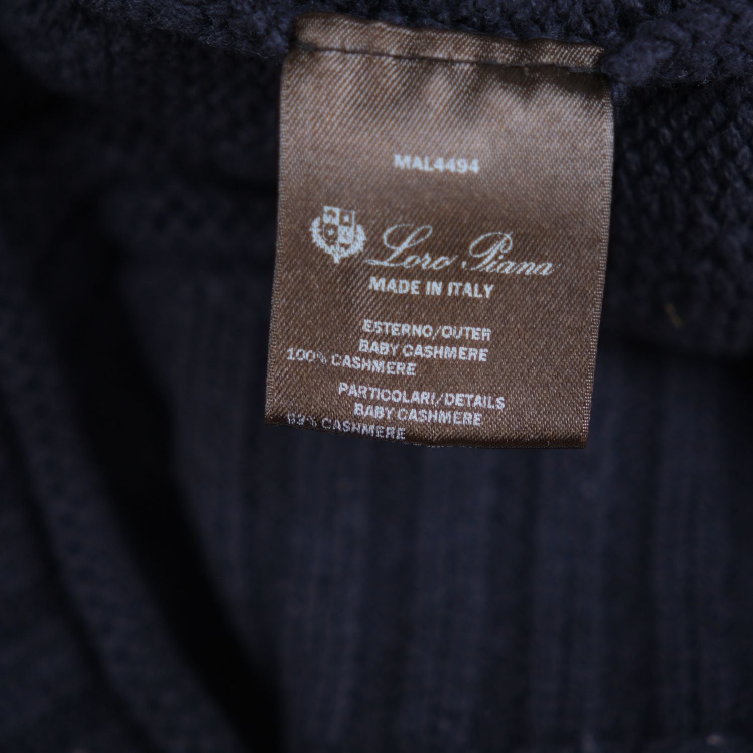 Close-up of the Loro Piana composition label reading 100% Baby Cashmere, Made in Italy