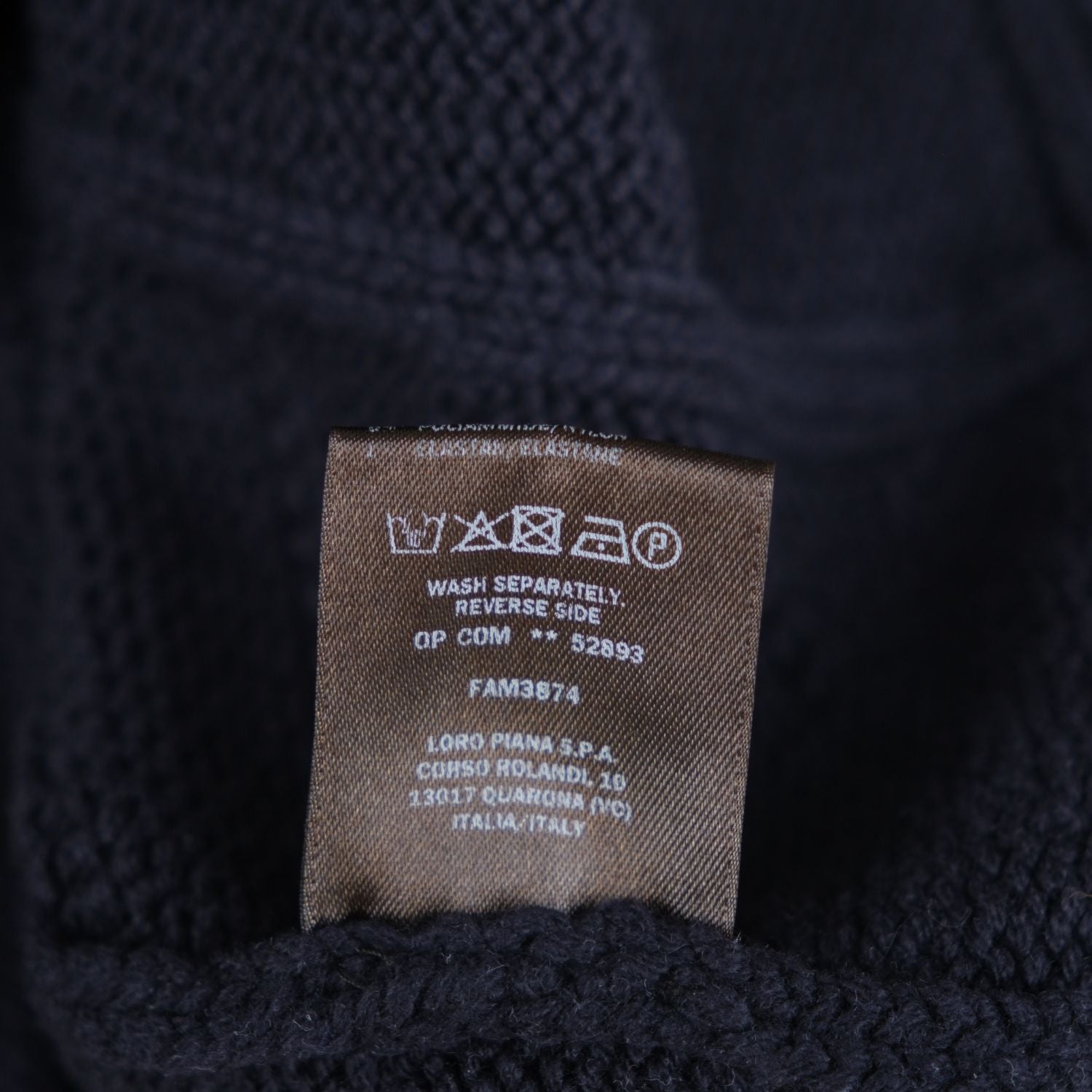 Close-up of the Loro Piana turtleneck's care and wash instructions label