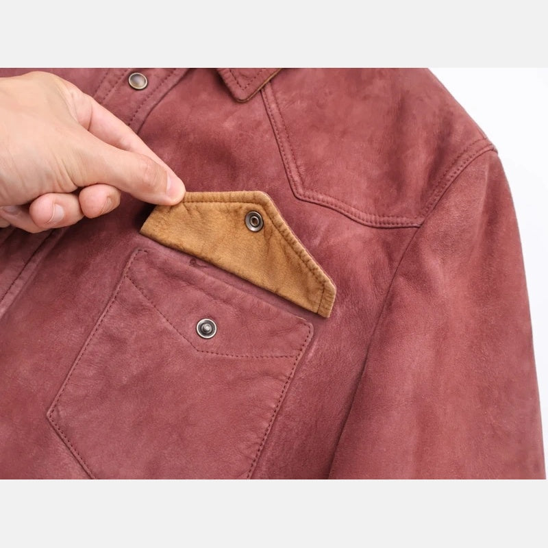 Detail of the snap-button chest pocket on the Brunello Cucinelli shearling trucker jacket, lined in camel shearling
