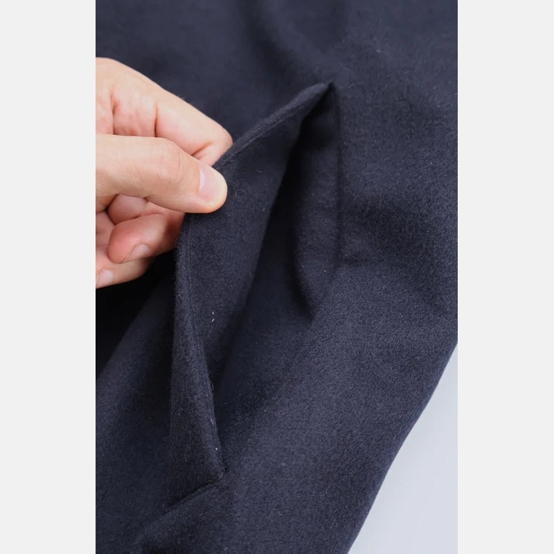 Close-up of the soft cashmere fabric texture on the Loro Piana navy bomber jacket